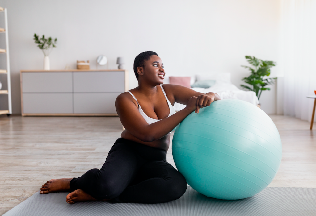 Woman exercising on sports mat at home