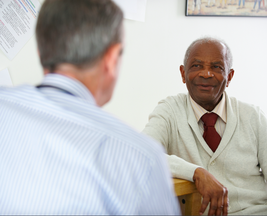Elderly man talking to doctor