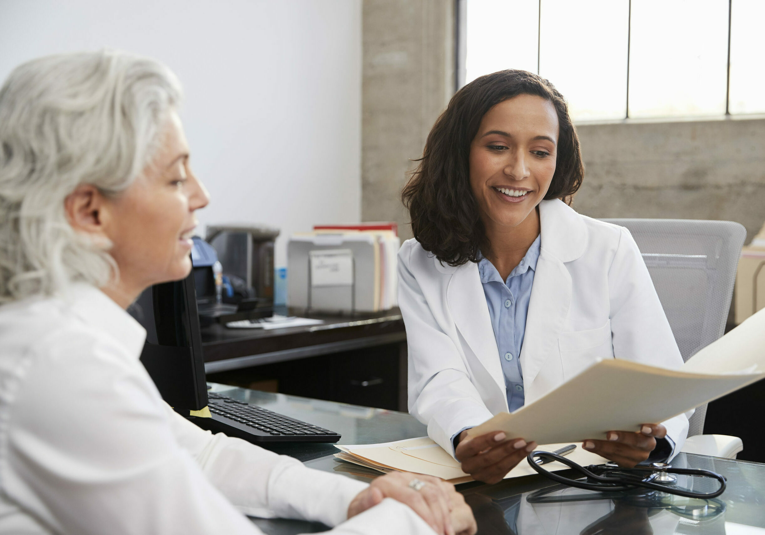 Smiling healthcare worker consulting with a patient